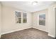 Bedroom featuring neutral carpet and two windows at 118 Strickland St, Fairburn, GA 30213