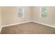 Bedroom with neutral carpet and two windows at 118 Strickland St, Fairburn, GA 30213