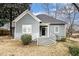 Traditional home features gray siding and stone accents, front steps to entry, and professional landscaping at 118 Strickland St, Fairburn, GA 30213