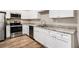 Kitchen featuring stainless steel appliances, granite countertops, and white cabinets at 118 Strickland St, Fairburn, GA 30213