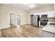 Open kitchen featuring stainless steel appliances, granite countertops, and hardwood floors at 118 Strickland St, Fairburn, GA 30213