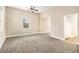Spacious living room with neutral carpet and a ceiling fan at 118 Strickland St, Fairburn, GA 30213