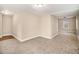 A large living room with carpet and hardwood floors to the right side at 118 Strickland St, Fairburn, GA 30213