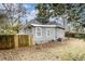 Charming home exterior showcasing gray siding, backyard, and a wooden fence at 118 Strickland St, Fairburn, GA 30213