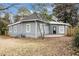 Backyard of a home with gray siding, featuring windows and a patio at 118 Strickland St, Fairburn, GA 30213
