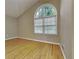 Hardwood floor bedroom with large arched window at 4048 Rainbow Dr, Decatur, GA 30034