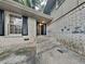 Brick front entrance with black door and steps leading to the house at 4048 Rainbow Dr, Decatur, GA 30034