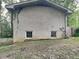 Brick rear exterior with two basement windows at 4048 Rainbow Dr, Decatur, GA 30034