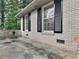 Brick side exterior with black shutters and a concrete patio at 4048 Rainbow Dr, Decatur, GA 30034
