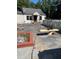 Concrete patio area with a bench and small garden at 4654 Hope Springs Rd, Stone Mountain, GA 30083