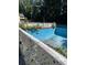 In-ground pool with a surrounding fence at 4654 Hope Springs Rd, Stone Mountain, GA 30083