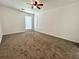 Spacious bedroom with ceiling fan and window at 798 Windchase Ln, Stone Mountain, GA 30083