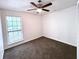 Bright bedroom with ceiling fan and window at 798 Windchase Ln, Stone Mountain, GA 30083