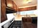 Kitchen features wood cabinets and gas range at 798 Windchase Ln, Stone Mountain, GA 30083