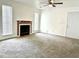 Spacious living room with fireplace, carpet, and neutral walls, creating a welcoming atmosphere at 798 Windchase Ln, Stone Mountain, GA 30083