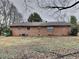 The rear exterior of this brick home has several small windows and a lawn at 1581 Wesley Nw Way, Conyers, GA 30012
