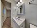 Bathroom features a modern vanity, framed mirror, and contemporary lighting at 1581 Wesley Nw Way, Conyers, GA 30012