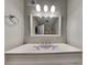 Updated vanity with decorative lighting in a gray-painted bathroom at 1581 Wesley Nw Way, Conyers, GA 30012