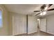 Spacious bedroom featuring wood-look floors, a ceiling fan, and a closet with folding doors at 1581 Wesley Nw Way, Conyers, GA 30012