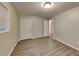 Bedroom with a closet, a light, wood floors, and a view of a side yard at 1581 Wesley Nw Way, Conyers, GA 30012