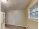 Bright bedroom with a large window, closet, and wood-look floors at 1581 Wesley Nw Way, Conyers, GA 30012