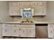 Bright kitchen features white cabinets, stainless steel appliances, and a garden window at 1581 Wesley Nw Way, Conyers, GA 30012