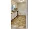 Bright kitchen has white cabinets, stainless steel appliances, and linoleum floors at 1581 Wesley Nw Way, Conyers, GA 30012