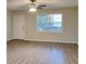 Bright living room features new laminate floors, a ceiling fan, and a large window at 1581 Wesley Nw Way, Conyers, GA 30012