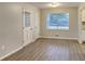 Cozy dining area features new laminate floors, a ceiling fan, and a large window at 1581 Wesley Nw Way, Conyers, GA 30012