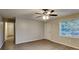 Bright living room with new laminate floors, a ceiling fan, a large window, and a closet at 1581 Wesley Nw Way, Conyers, GA 30012