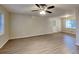Spacious living area with new laminate floors, ceiling fan, and multiple windows at 1581 Wesley Nw Way, Conyers, GA 30012