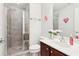 Bright bathroom featuring a glass shower, tile floors, and a vanity sink at 2732 Wander Ln, Alpharetta, GA 30022