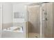 Bright bathroom featuring a jacuzzi style tub and glass enclosed shower at 2732 Wander Ln, Alpharetta, GA 30022