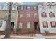 Charming three-story brick townhouse with black shutters and well-maintained landscaping at 2732 Wander Ln, Alpharetta, GA 30022