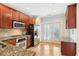 Well-lit kitchen featuring granite countertops, stainless steel appliances, and hardwood flooring at 2732 Wander Ln, Alpharetta, GA 30022