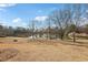 Tranquil lake view with trees and a distant gazebo at 2732 Wander Ln, Alpharetta, GA 30022