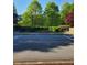 A street with manicured green spaces and lush trees that enhance the street appeal at 2732 Wander Ln, Alpharetta, GA 30022