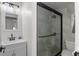 Modern bathroom with a large glass shower and white vanity at 300 Peachtree St # 24-I, Atlanta, GA 30305