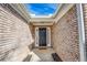 Brick entryway with a dark brown door and a small walkway at 4078 Savannah Ridge Ct, Loganville, GA 30052