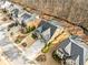 Aerial view of meticulously landscaped homes surrounded by lush greenery and mature trees at 1545 Camden Cove Dr, Cumming, GA 30040