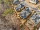 Aerial view of homes surrounded by mature trees, landscaped yards, and well-maintained lawns at 1545 Camden Cove Dr, Cumming, GA 30040