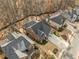 An aerial view of the rear of a home showcasing the expansive backyard and wooded surroundings at 1545 Camden Cove Dr, Cumming, GA 30040