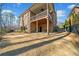 Backyard showing the brick home with a covered patio overlooking the yard at 1545 Camden Cove Dr, Cumming, GA 30040