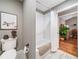 Bathroom featuring a toilet, bathtub with shower, white subway tile, and rustic decor at 1545 Camden Cove Dr, Cumming, GA 30040