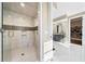 Modern bathroom showcasing a glass-enclosed shower and vanity leading to the walk-in closet at 1545 Camden Cove Dr, Cumming, GA 30040