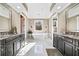 Elegant bathroom with a freestanding tub, double vanities, marble floors and large windows with natural light at 1545 Camden Cove Dr, Cumming, GA 30040