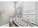 Close up of bathroom vanity featuring granite countertop, white cabinetry, and lighting at 1545 Camden Cove Dr, Cumming, GA 30040