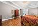 Bright main bedroom featuring a luxurious bed, dark wood furnishings, and large windows at 1545 Camden Cove Dr, Cumming, GA 30040