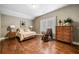 Cozy bedroom features hardwood floors, a rocking chair and natural light at 1545 Camden Cove Dr, Cumming, GA 30040