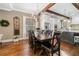 Elegant dining area with hardwood floors and a view into a modern kitchen with stainless steel appliances at 1545 Camden Cove Dr, Cumming, GA 30040